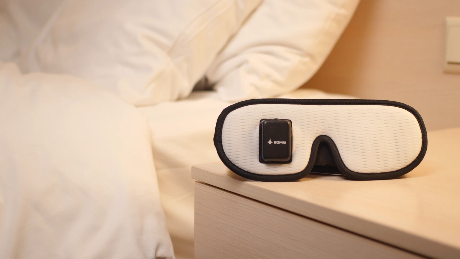 Somni Mask on a bedside table